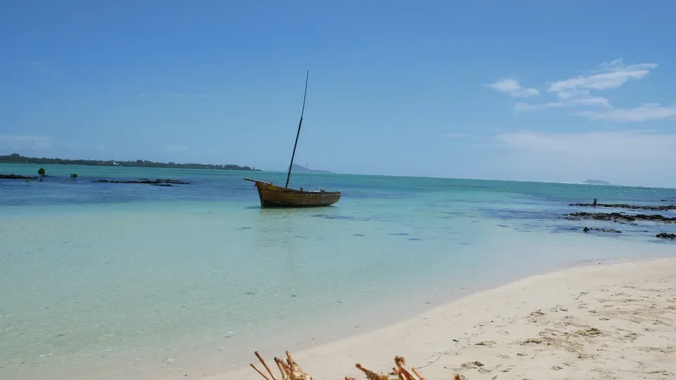 Wooden pirogue beside a Mauritius beach